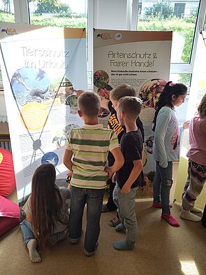 Schüler beim Betrachten von Plakaten